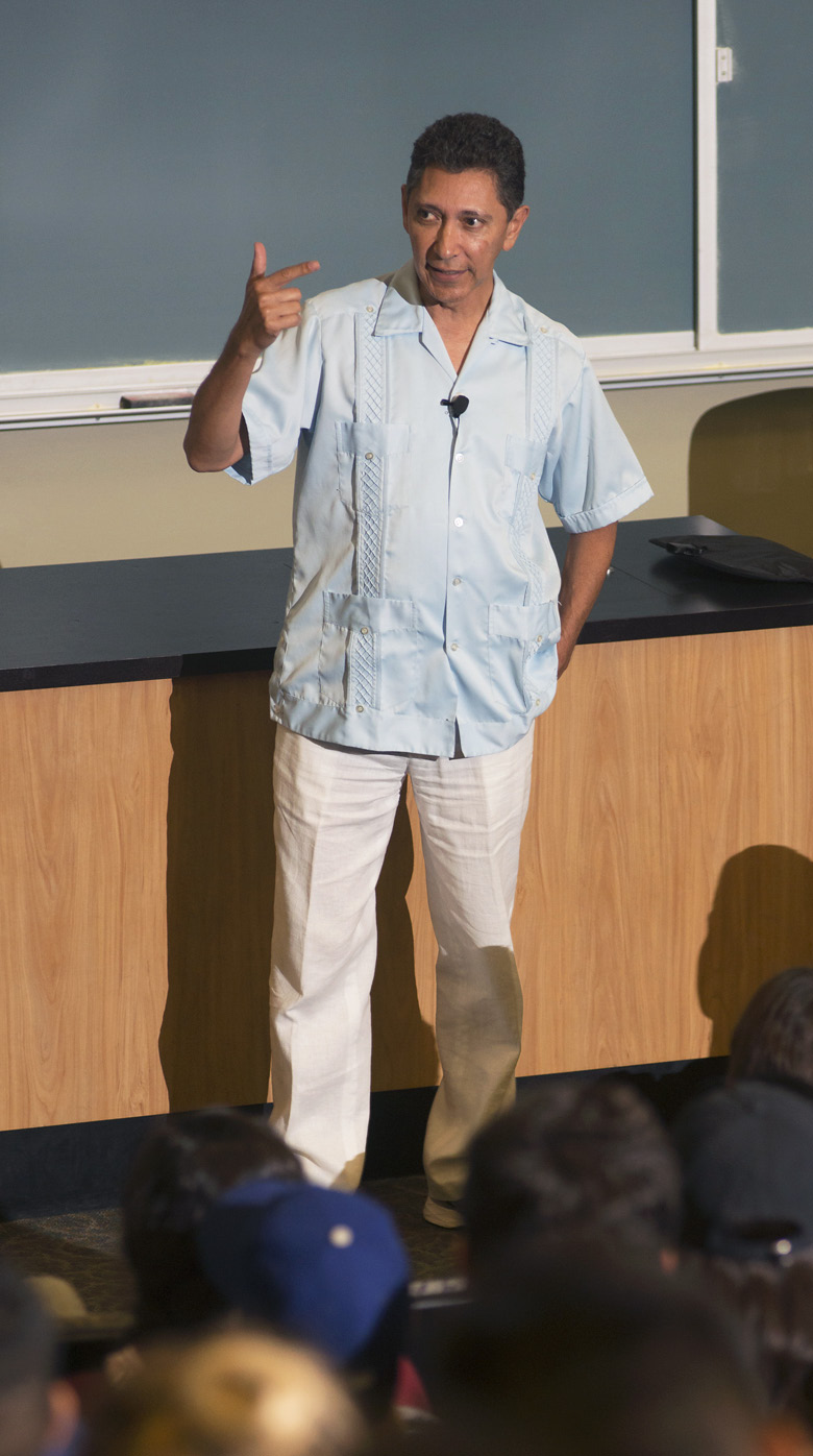 Arturo Gonzalez standing in front of lecture hall while talking