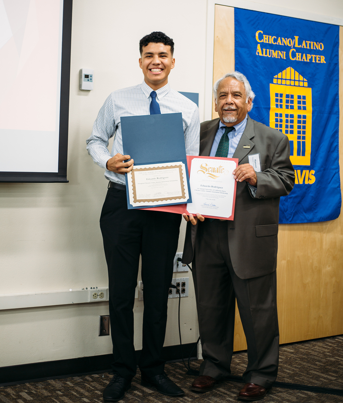 Student receiving  a scholarship from the Chicanx Latinx Alumni Association