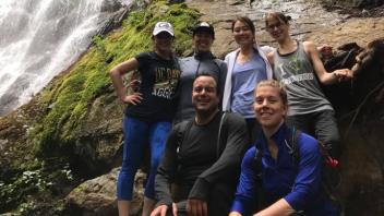 Seattle UC Davis alumni with a waterfall behind them