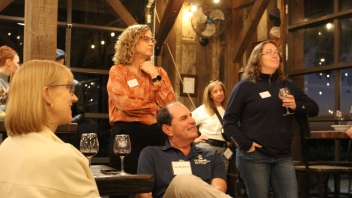 People listening to a talk about wine and the Herringer estate. 
