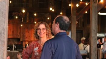 Women and man having a conversation and laughing.