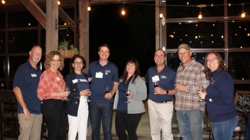 Group photo of people, some attendees , some staff of the Cal Aggie Alumni Center. 