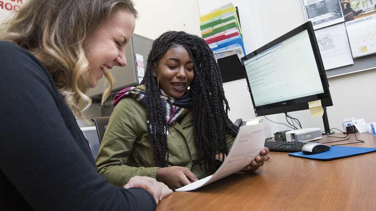 Two people looking at a piece of paper