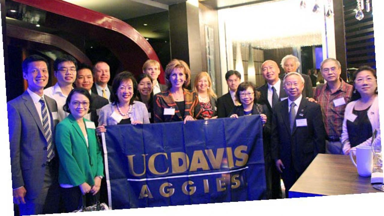 Chancellor Katehi with alumni, students and friends on October 19. A UC Davis Pennant.