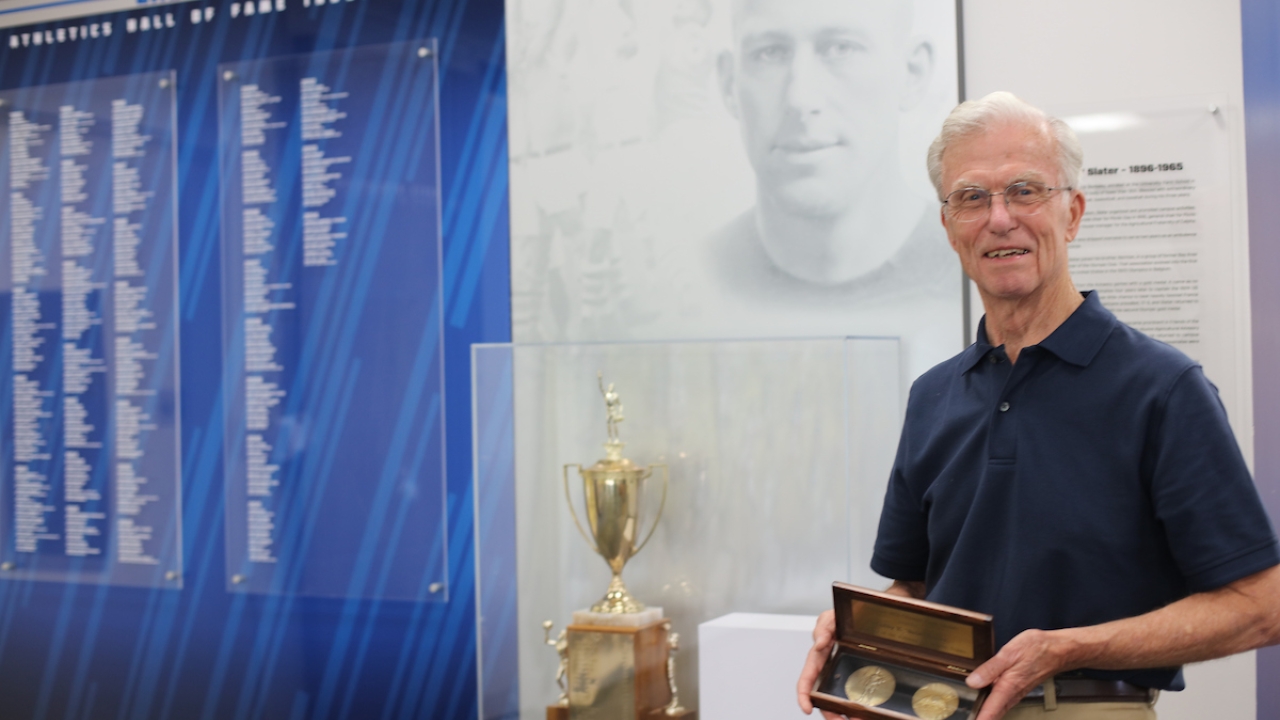 Dick McCapes, Babe Slater's son-in-law, with Slater's gold medals in the Colby E. "Babe" Slater Athletic Hall of Fame at UC Davis Dick McCapes