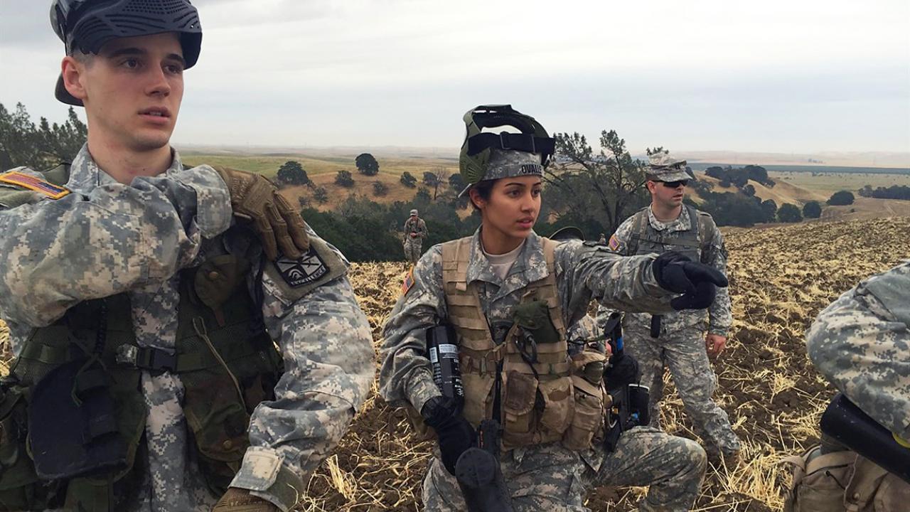Pauline Ovalle standing in a field with with her platoon