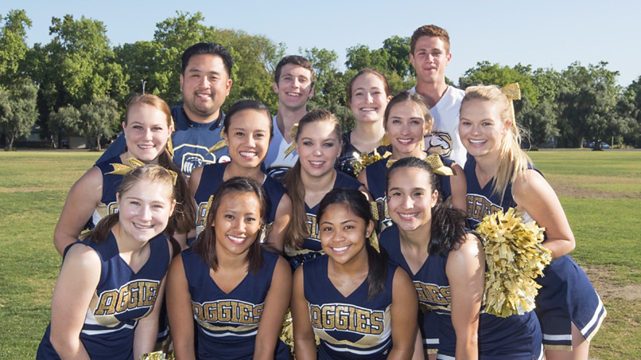 Reggie Higashi stands with UC Davis cheerleaders at Picnic Day 2015 Reggie Higashi