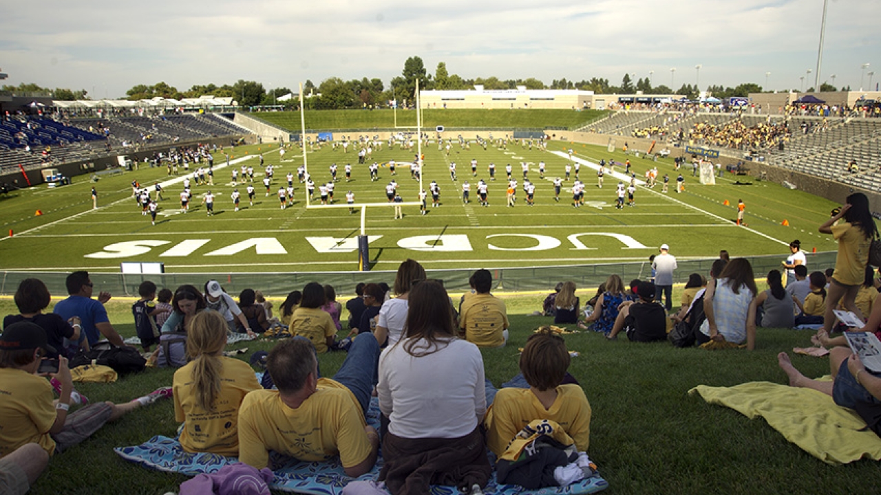 UC Davis fans sitting in Aggie Stadium watching football game