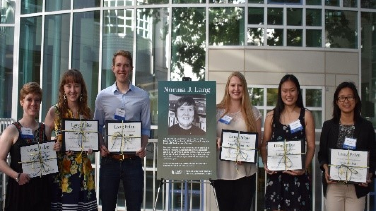 students posing with certificates