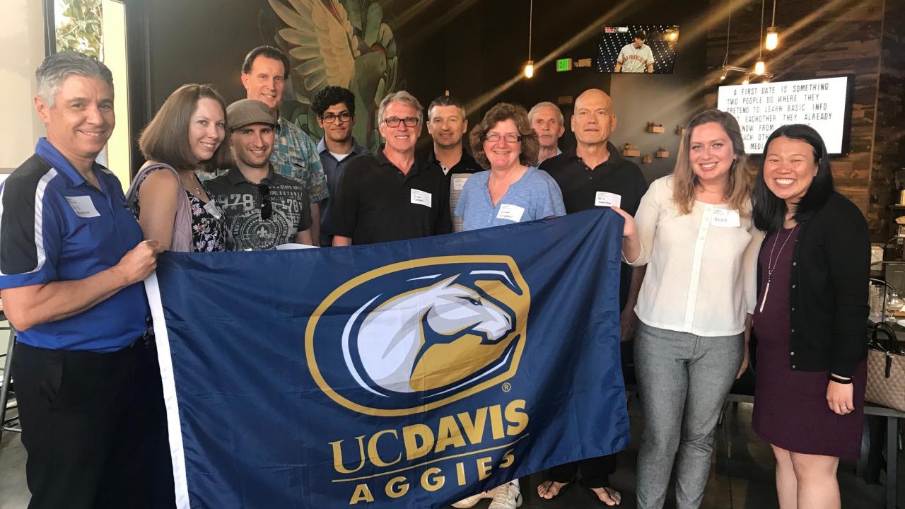 Group of alumni and friends at a 2018 happy hour