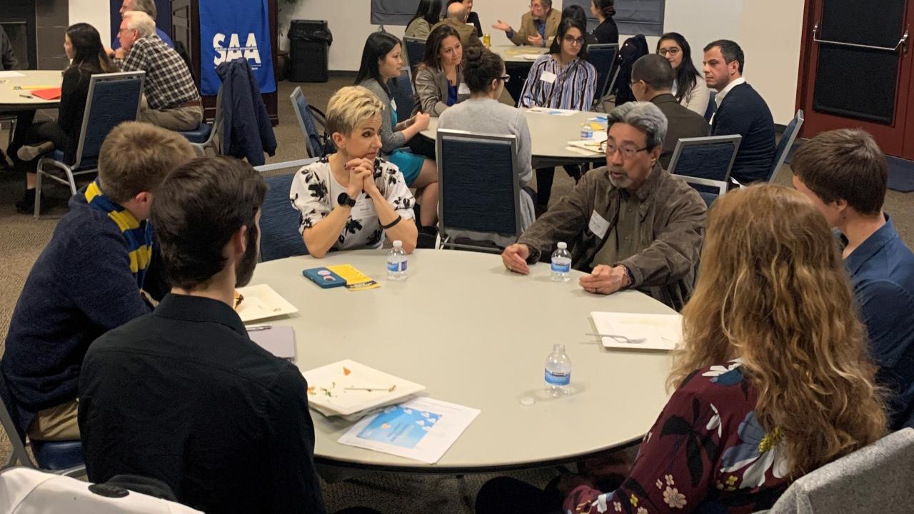 Picture of people sitting around a table for a networking event.