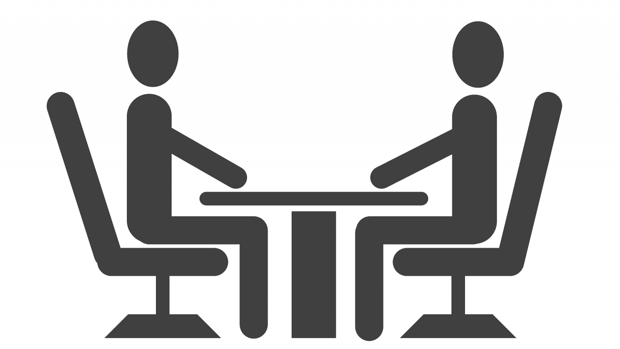 two people talking at a table