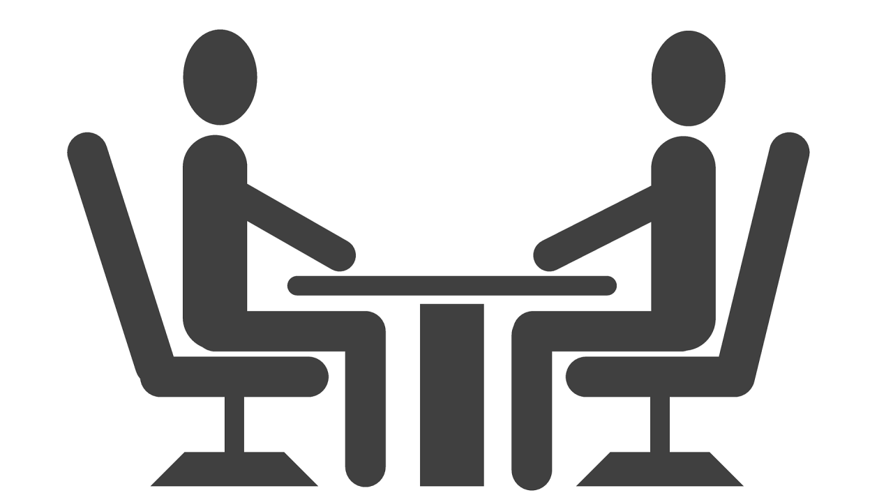 two people talking at a table