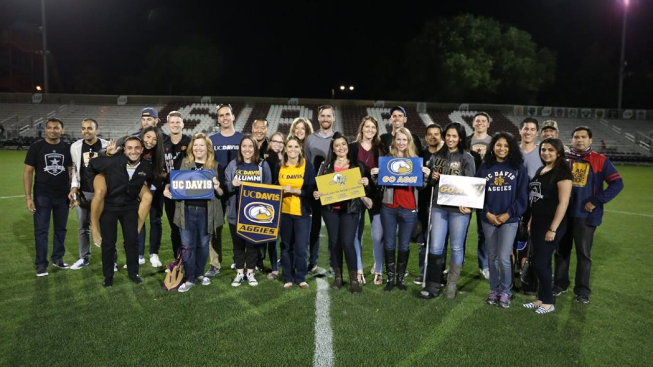 Group of Aggies on football field.