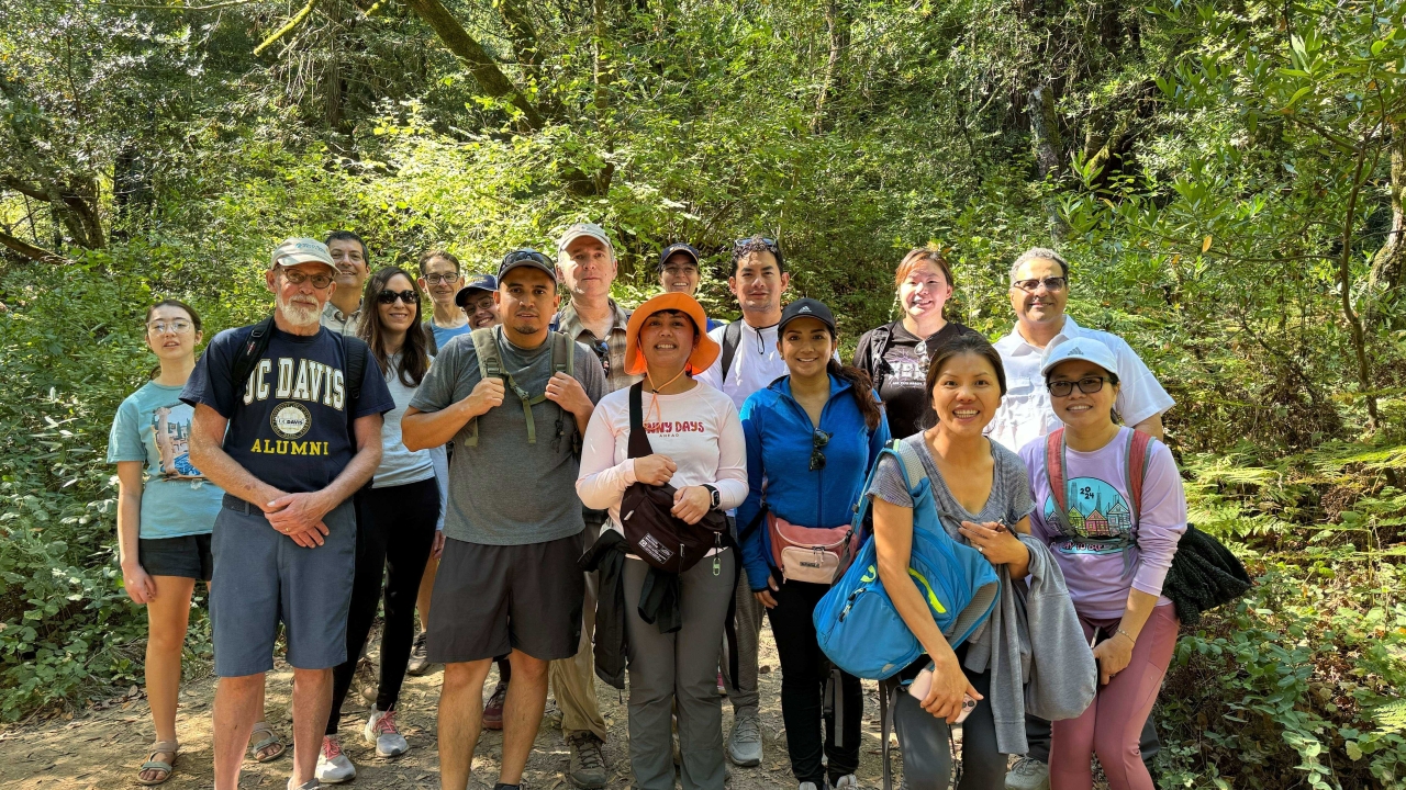 Group of hikers in a forest landscape posing for a picture.