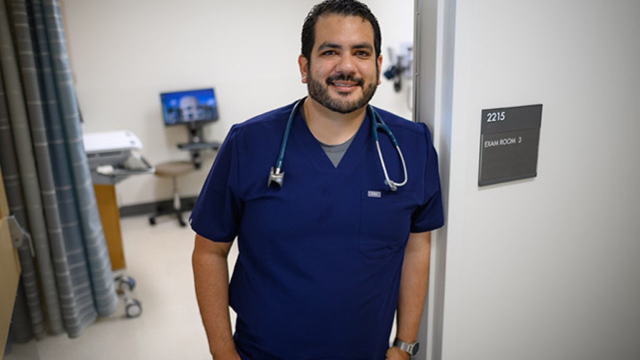 Matthew Vega standing outside a patient room in a medical setting