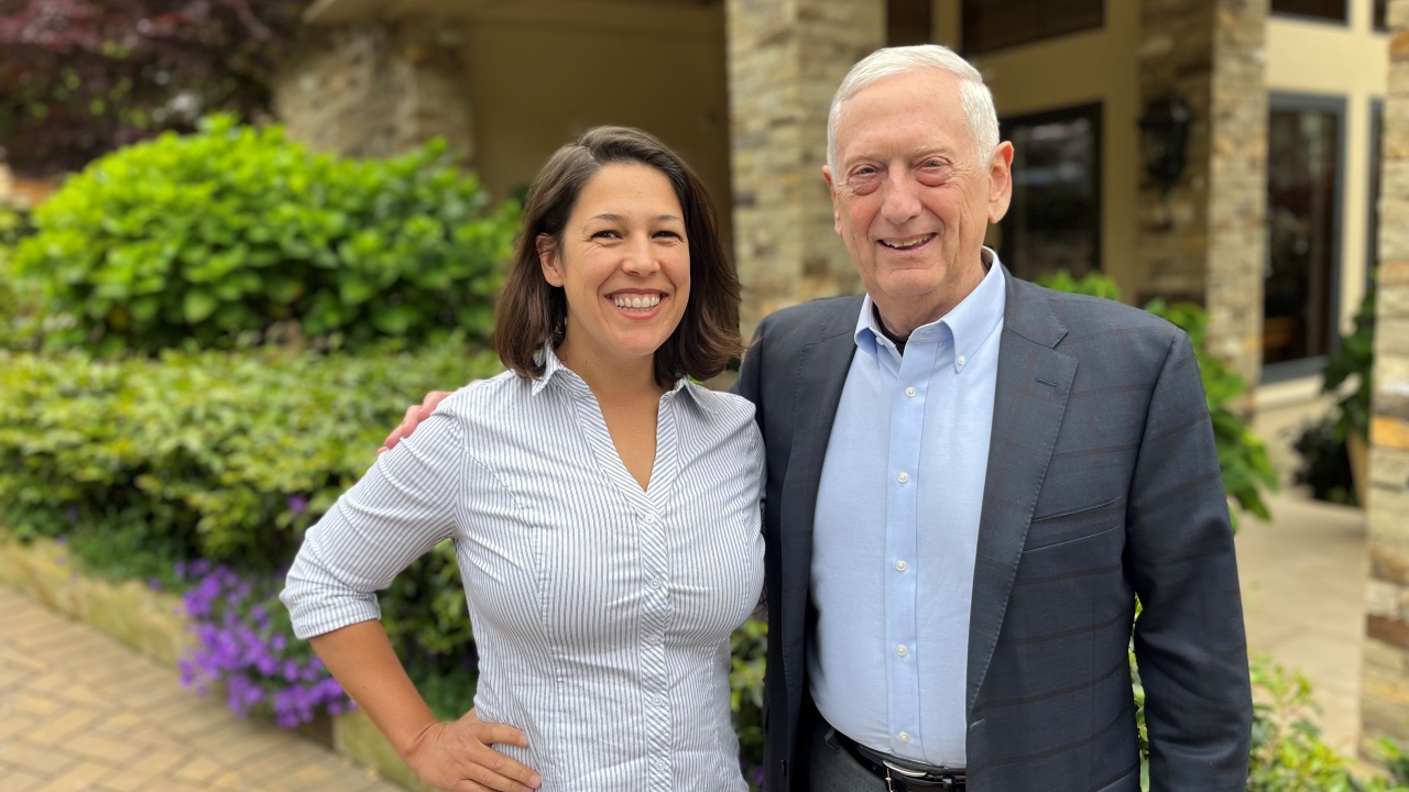 Mello and Mattis smiling for photo together outside in front of building.