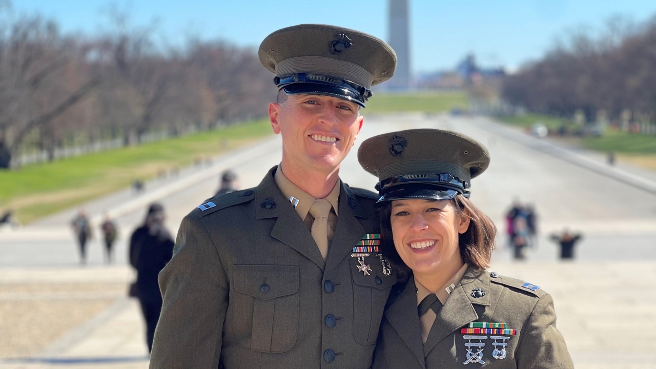 Maggie Mello and her husband posed in front of Washington Monument wearing military uniforms.