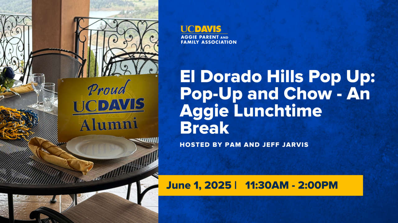 Set table with uc Davis alumni sign on it next to event text