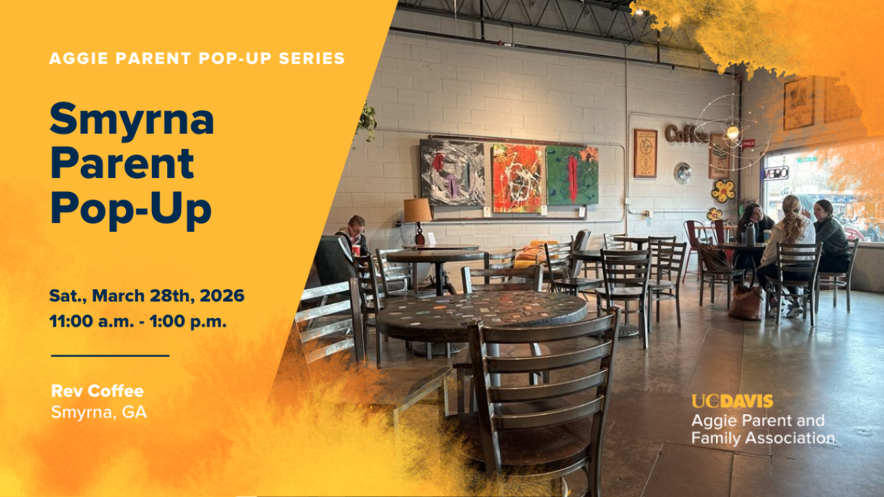 Brightly lit indoor space with tables and chairs, featuring colorful artwork on the walls.