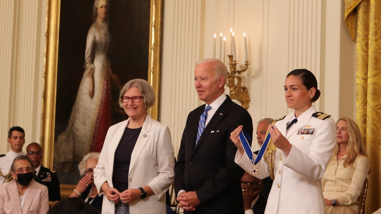Sister Simone Campbell, J.D. ’77, left, stands ready to receive the Presidential Medal of Freedom (held by a military aide) from President Joe Biden, July 7, in the East Room of the White House. (Network Lobby for Catholic Social Justice)