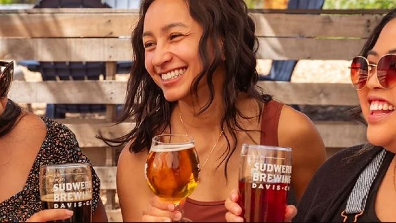 three women smiling, drinking Sudwerk beer 