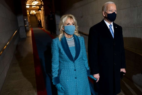 President Joseph R. Biden Jr. and his wife Dr. Jill Biden wait to walk onto the inaugural platform during the 59th Presidential Inauguration at the U.S. Capitol Building.