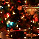 photo of a martini glass in front of a background of twinkle lights