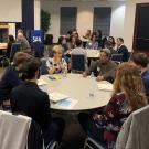 Picture of people sitting around a table for a networking event.