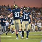 Picture of Jake Maier and Wes Preece high fiving on the football field