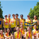 Group photo of UC alumni in yellow shirts with medals on after the Vitality race.