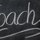 Hand writing coach in chalk on a chalkboard