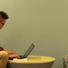 A man sits at the MU and uses his laptop