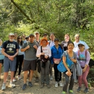 Group of hikers in a forest landscape posing for a picture.