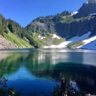 serene lake with mountains and trees off in the distance