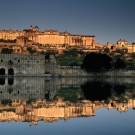 A picture of Amber Fort in Jaipur that shows the buildings mirrored on the water's surface.