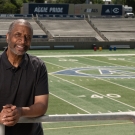 Ron Austin poses in the stands of the UC Davis football stadium.