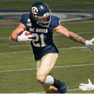 UC Davis football player juking a Cal Poly player
