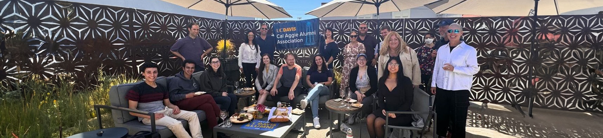 A group of alumni from the Jewish Alumni Network pose on the patio of a wine tasting event.